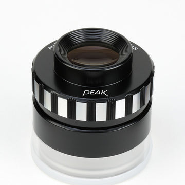Λούπα Peak Anastigmatic 10x 1990x4, μαύρη κυλινδρική με μεταλλικό δαχτυλίδι και μεγάλο φακό επάνω